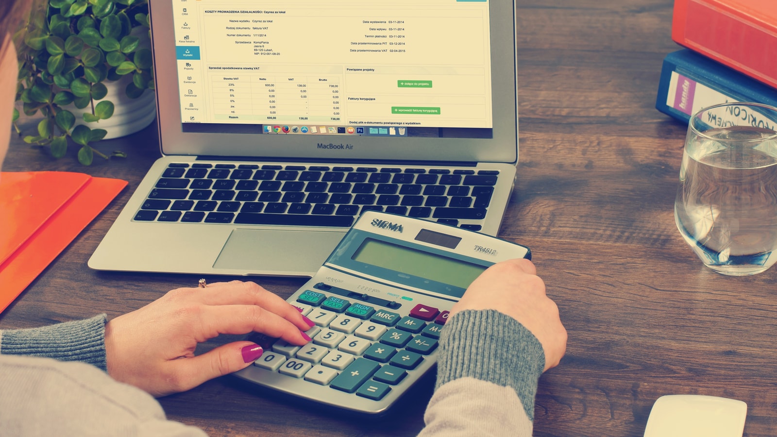 Business tax paperwork and calculator on an office desk