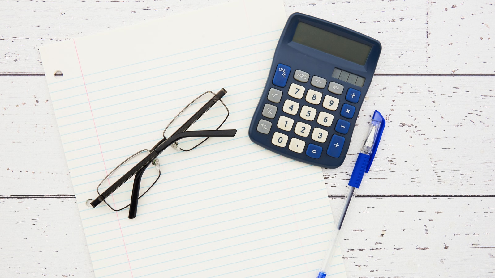 Business tax paperwork and calculator on an office desk