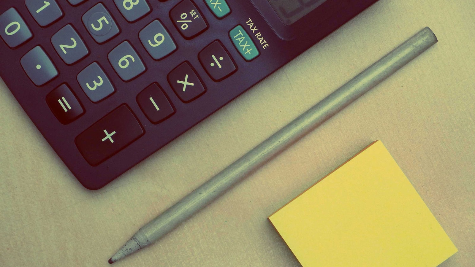 Business tax paperwork and calculator on an office desk