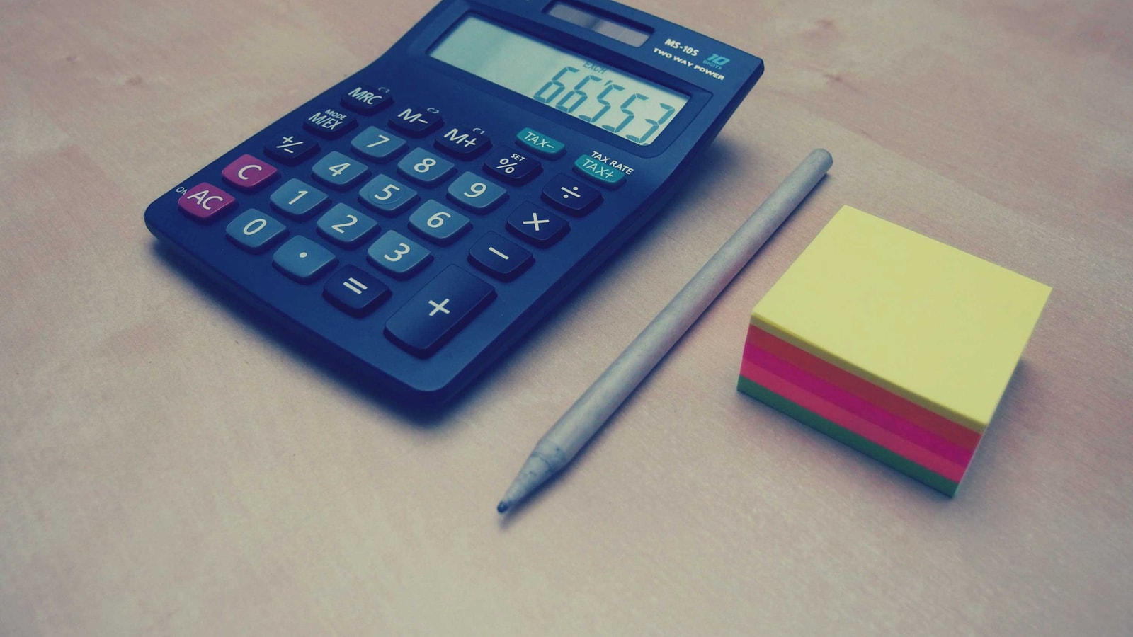 Business tax paperwork and calculator on an office desk